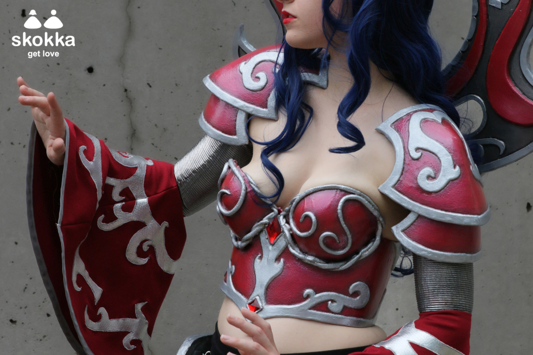 An image of a cosplay escort dressed in burgundy armour.