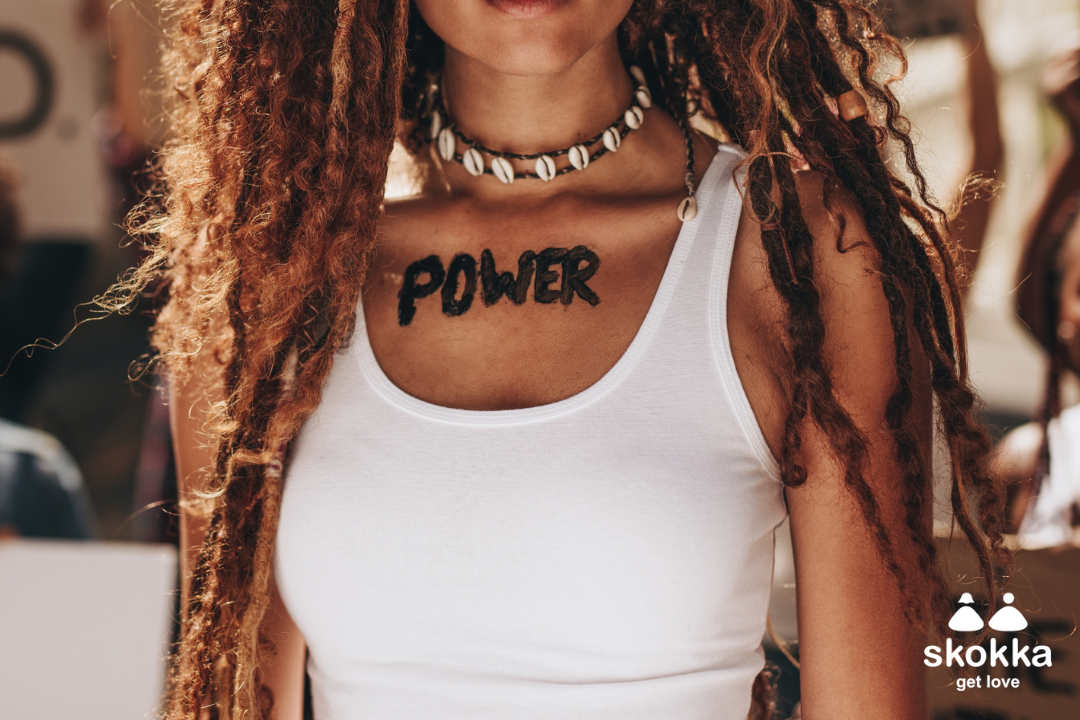 A woman with power written on her chest to represent International Sex Workers' Rights Day 2025.